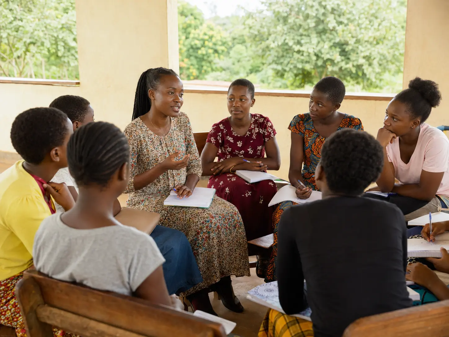 A female mentor leading a safe-space conversation with girls